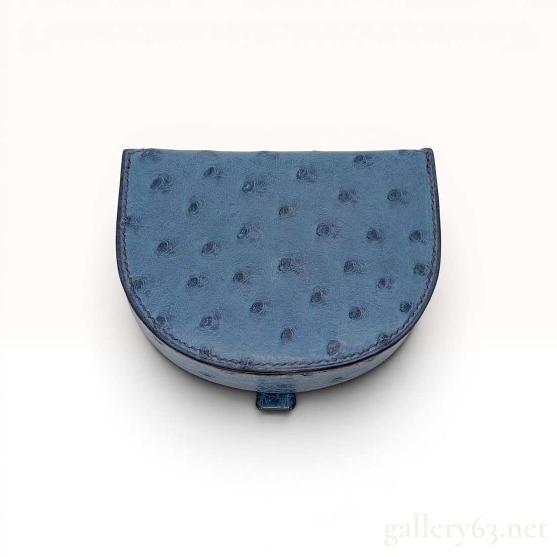 Hermes Blue Ostrich Leather Horseshoe Coin Purse: This Hermes horseshoe-shaped coin purse is crafted from blue ostrich leather, featuring the material's characteristic raised quill pattern and hand-stitched saddle-stitching with tonal thread. The str