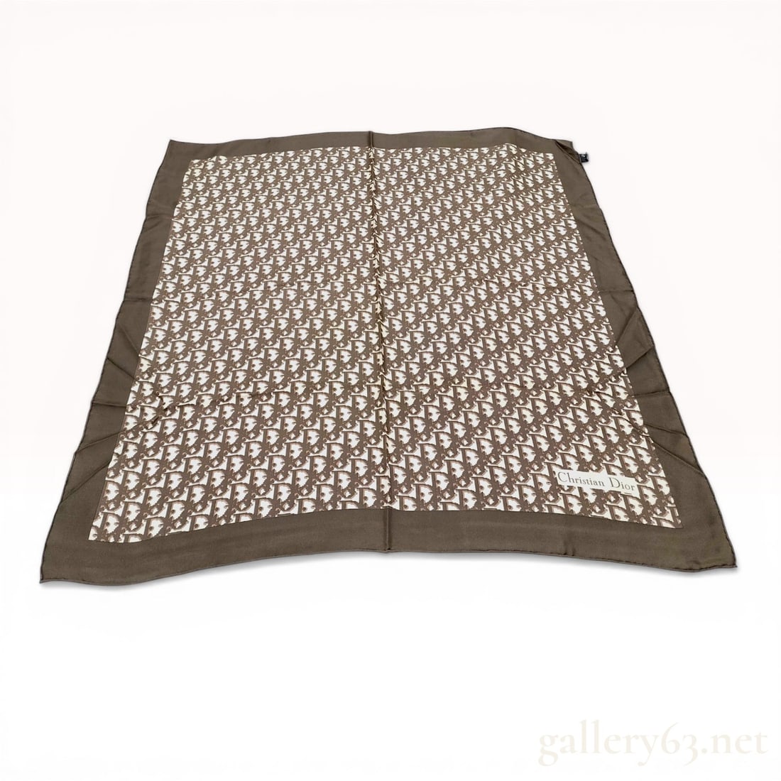 Christian Dior Brown Oblique Monogram Silk Scarf: Christian Dior silk scarf featuring the signature Oblique monogram pattern in brown against a cream field. The design is framed by a solid dark brown border and finished with hand-rolled edges. A blac