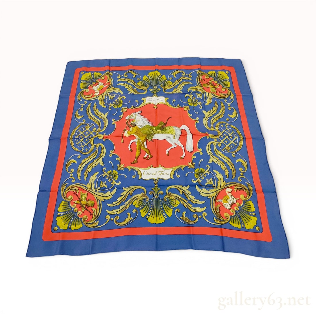 Hermes Silk Carre Scarf Cheval Turc Pattern by Christiane Vauzelles: A vintage silk carre scarf manufactured by Hermes, featuring the Cheval Turc pattern designed by Christiane Vauzelles. The central motif depicts a caparisoned white horse led by a groom in traditional