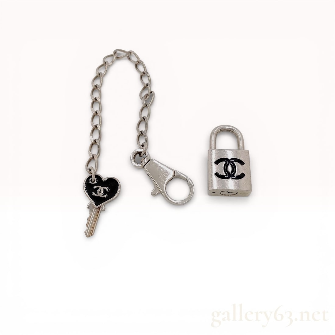 07P Chanel Lock Motif Chain Bracelet with Padlock and Key Charm 7': Rare Chanel Lock Motif Chain Bracelet with Padlock and Key Charm. 2007 spring collection. 07P. Chanel bracelet featuring a silver-tone chain design incorporating a padlock charm accented with black en