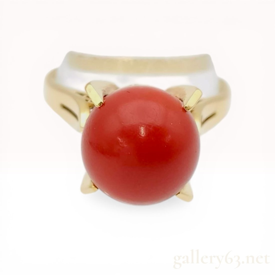 Estate Vintage Coral & 18K Yellow Gold Cocktail Ring: 18 karat yellow gold cocktail ring featuring a large round red coral cabochon, mid to late 20th century. The central stone is secured in a four-prong setting atop an ornate openwork gallery with scrol