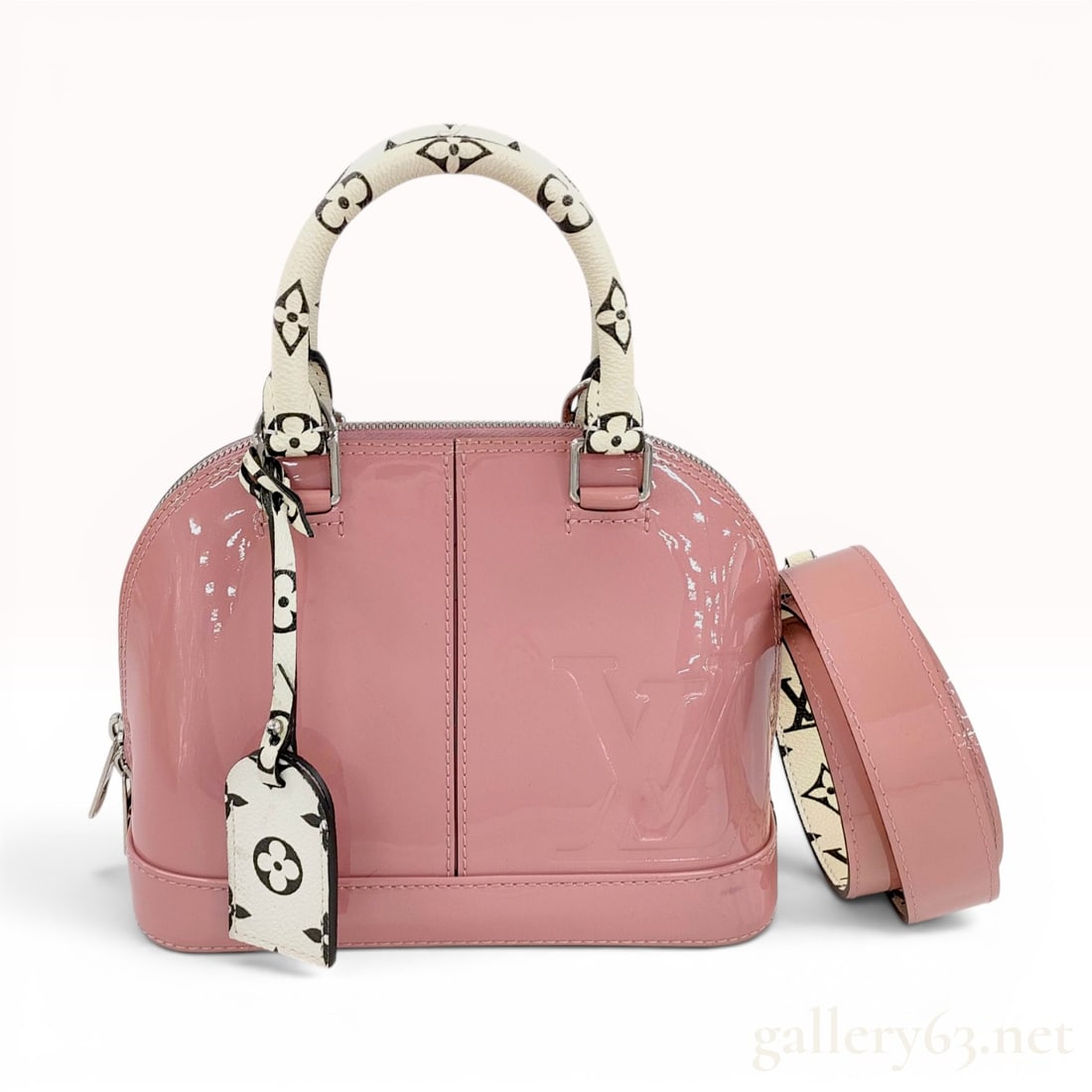 Louis Vuitton Rose Blush Monogram Vernis Alma BB Handbag: This Louis Vuitton Alma BB handbag is crafted from Rose Blush Monogram Vernis patent leather featuring a large embossed LV logo on the front face. The design includes dual top handles and a matching d