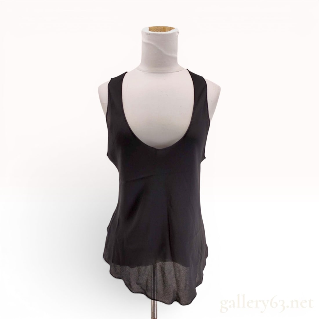 Hermes Black Silk Sleeveless Scoop Neck Top: This Hermes sleeveless top is crafted from 100 percent black silk georgette. The garment features a deep scoop neckline and a high back with a loose-fitting, slightly flared silhouette. The fabric has