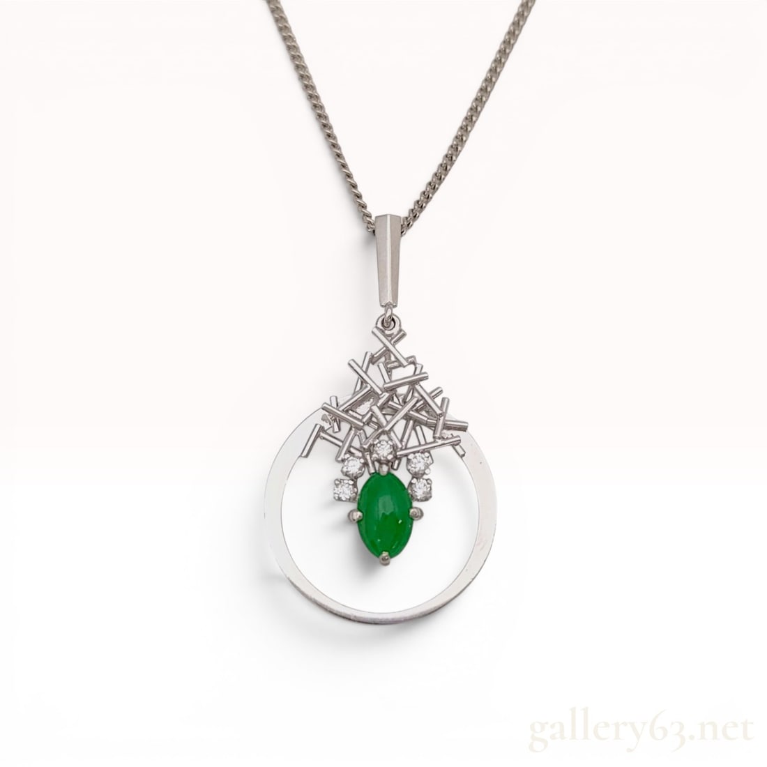 Japanese Modernist.900 Platinum Apple Green Jadeite Jade and Diamond Pendant Necklace: A Japanese modernist pendant necklace crafted in.900 platinum. The pendant features a central oval cabochon-cut green jadeite jade measuring approximately 8mm x 5.5mm. The gemstone is prong-set at the
