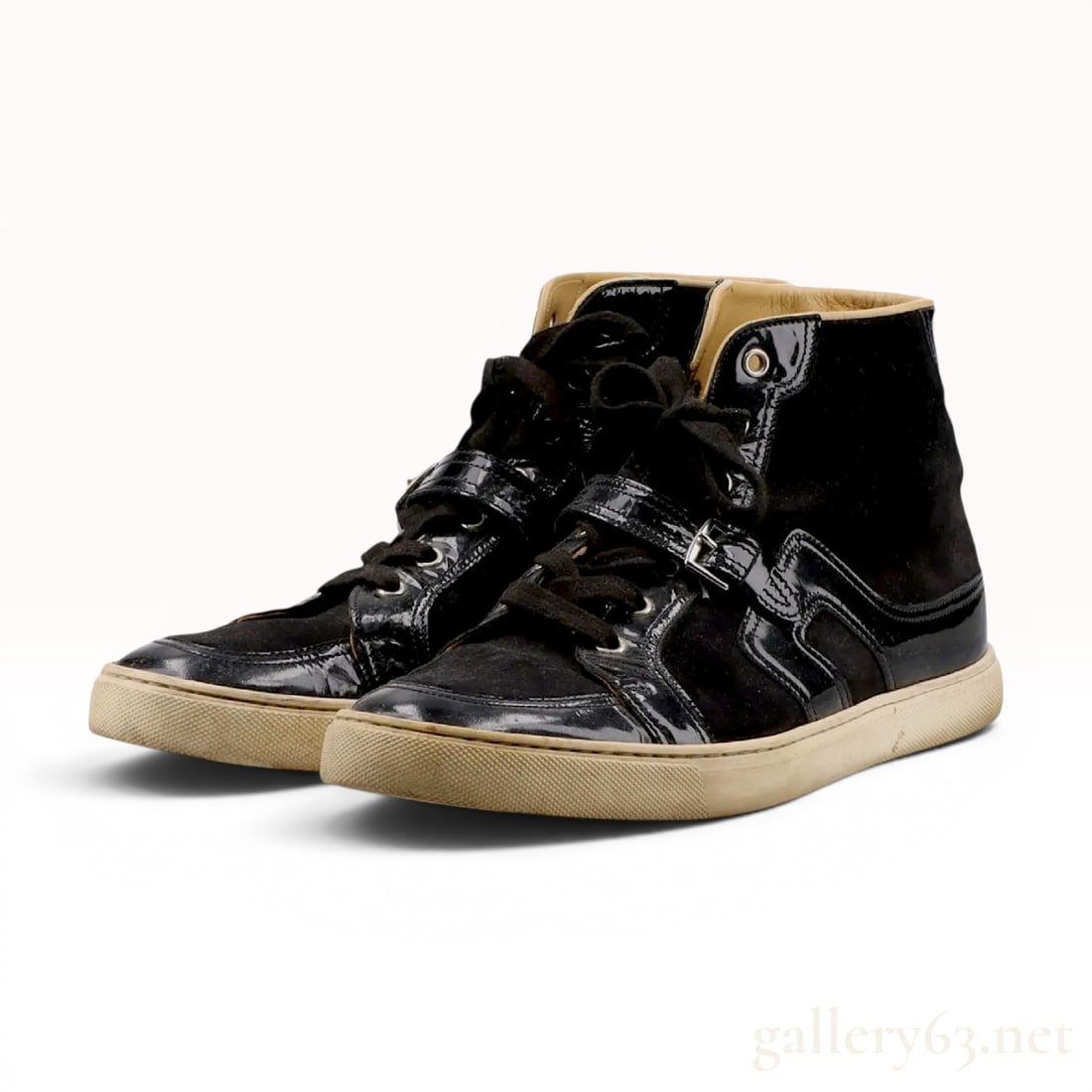 A Pair of Hermes Black Suede and Patent Leather Quantum High-Top Sneakers: A pair of Hermes Quantum high-top sneakers constructed with a combination of black suede and patent leather panels. The design features a traditional lace-up closure and a patent leather cross-strap w