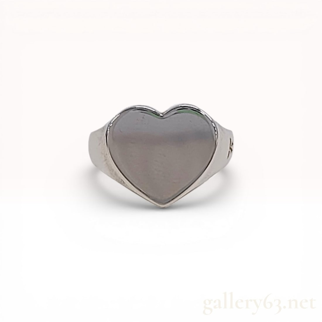 Tom Wood Sterling Silver Heart Signet Ring: Tom Wood sterling silver heart signet ring, contemporary. The ring features a heart-shaped face bezel-set with a polished greyish-white stone on a tapering band. The interior of the band is stamped 92