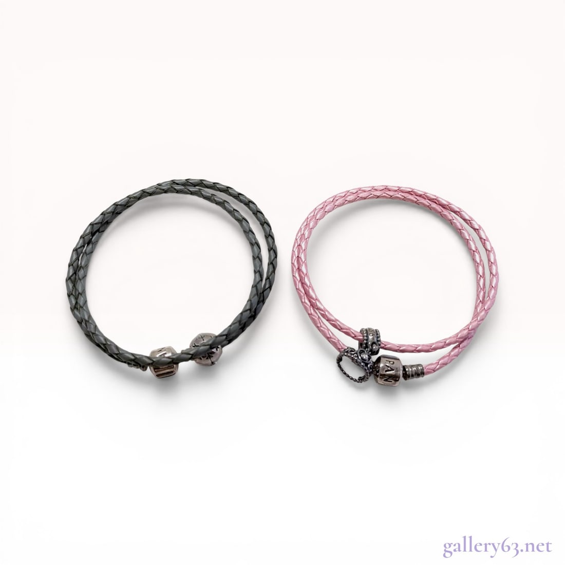 Two Pandora Double-Wrap Braided Leather Bracelets with Charms: Pandora double-wrap braided leather bracelets, contemporary. The lot includes one charcoal gray leather bracelet with a spherical openwork charm containing a light blue stone and one shimmering pink l