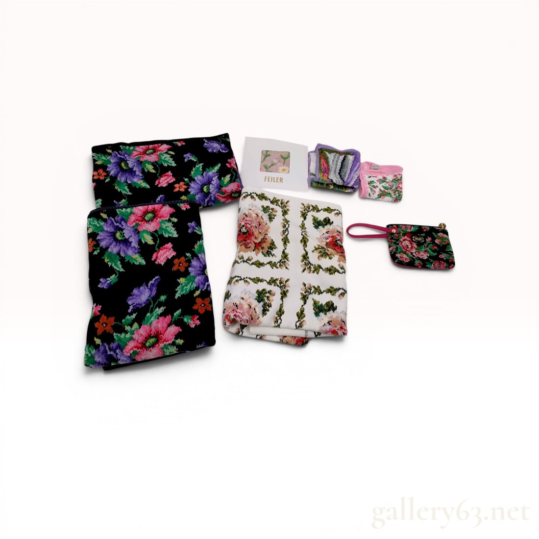 A Collection of Seven Feiler German Chenille Floral Textile Items: An assortment of seven floral cotton chenille textile items by Feiler, Germany. The collection features various intricate rose and wildflower patterns on contrasting black, white, and pink backgrounds