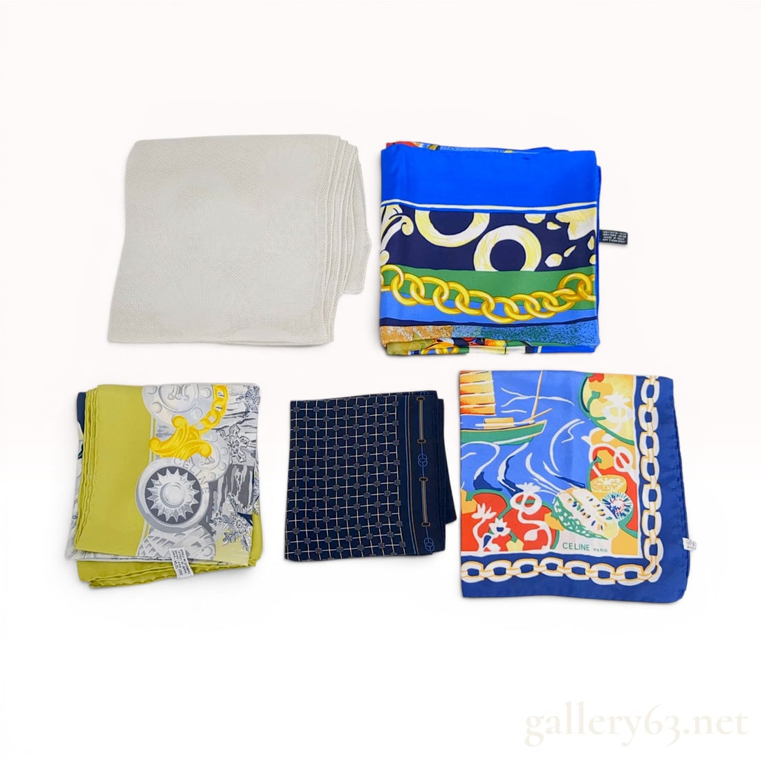 A Group of Five Celine Silk Scarves: Group of five silk scarves by Celine, late 20th century. Includes printed designs with nautical fruit motifs, carriage harness and snowflake patterns, a geometric micro-monogram, a striped chain-link 