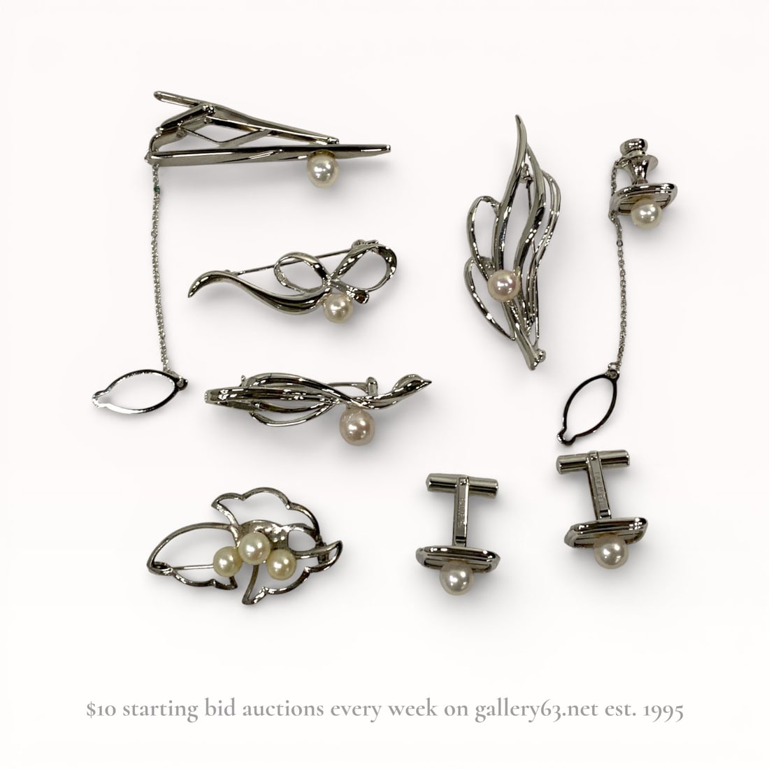 An Eight-Piece Collection of Silver and Cultured Pearl Jewelry, Mid 20th C.: An eight-piece collection of silver and cultured pearl jewelry, mid-20th century. The group includes four brooches with abstract leaf and ribbon motifs featuring rollover safety clasps, a pair of rect