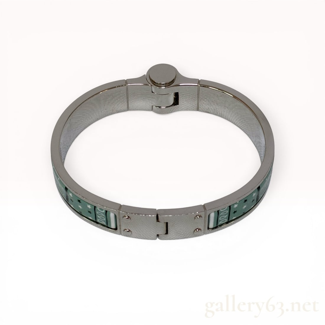 Hermes Tenues de Jour Enamel Hinged Bangle Bracelet: Hermes Tenues de Jour enamel hinged bangle bracelet, manufactured in France. The silver-toned metal frame features inlaid enamel panels decorated with pink floral bottle motifs, green polka dots, and 