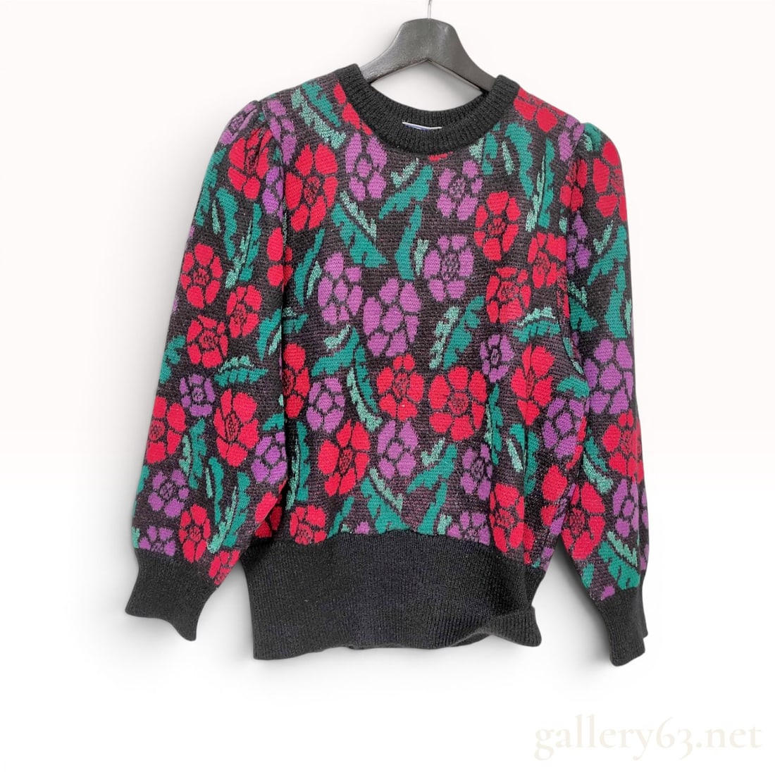 Yves Saint Laurent Tricots Vintage Floral Wool Blend Sweater, Circa 1980s: Vintage Yves Saint Laurent Tricots pullover sweater, circa 1980s. The garment features an all-over floral jacquard pattern in shades of red and purple with metallic green lurex accents on a black grou