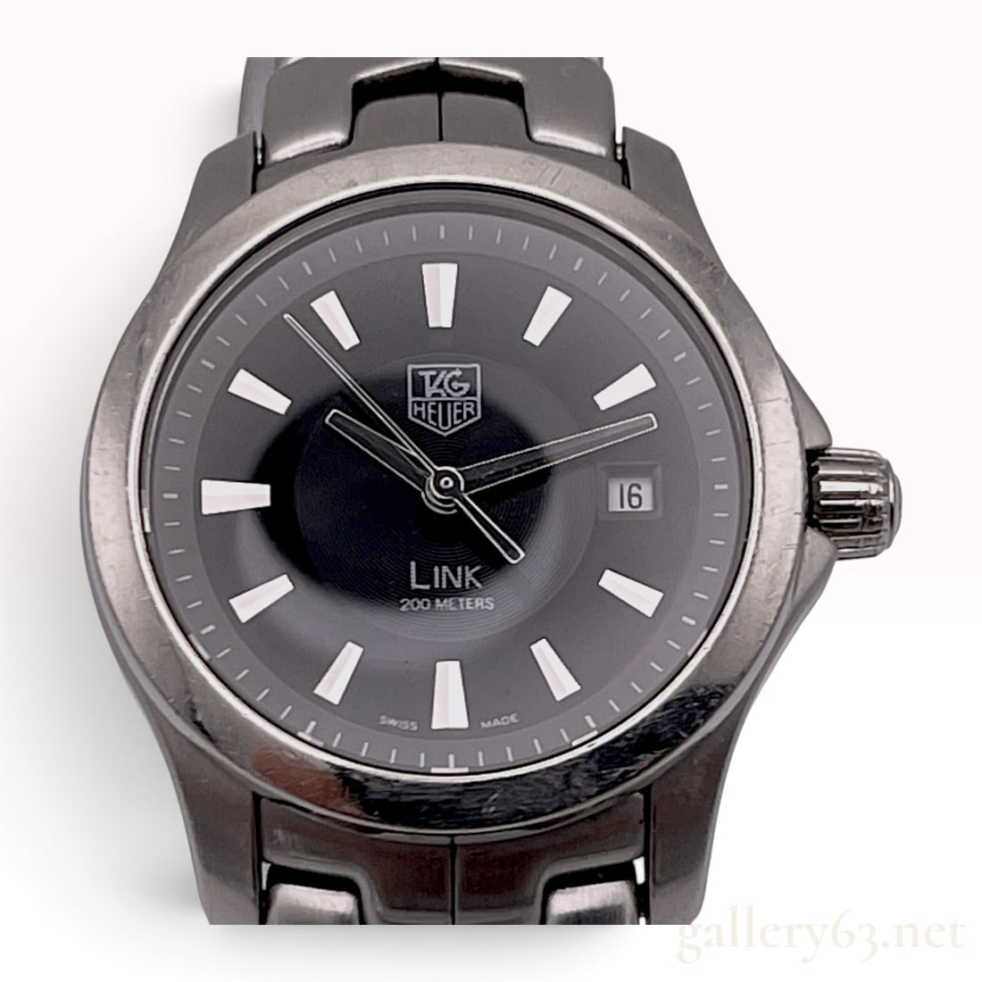 TAG Heuer Link Ladies Stainless Steel Quartz Wristwatch Reference WJF1313: TAG Heuer Link wristwatch, reference WJF1313, featuring a stainless steel case and the signature S-link bracelet. The black dial is configured with baton hour markers, a date window at the 3 o'clock p