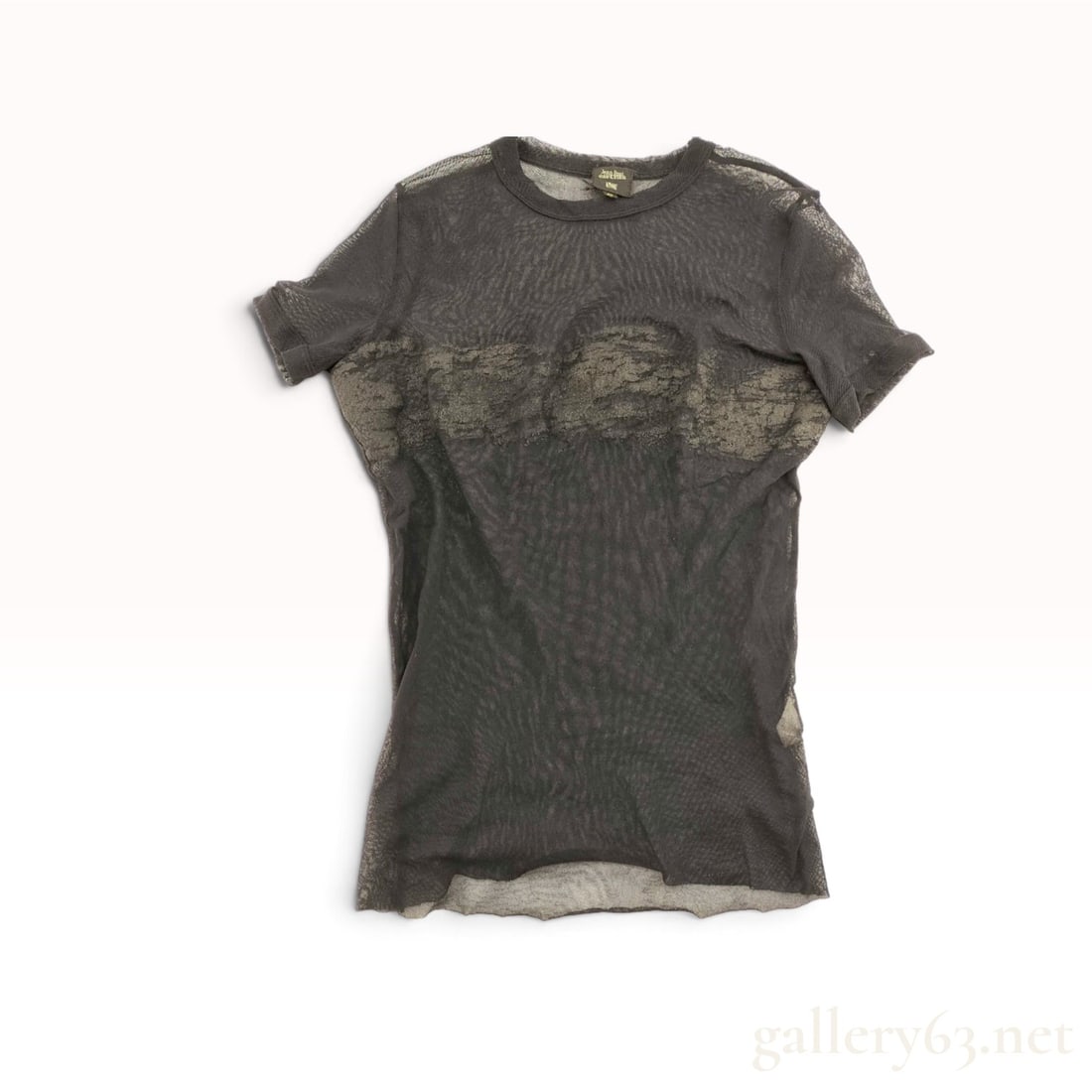 Jean Paul Gaultier Homme Trompe l'Oeil Lace Mesh T-Shirt: A vintage short-sleeved mesh T-shirt by Jean Paul Gaultier Homme. The garment is constructed from 100% sheer black nylon mesh and features a crew neckline and short sleeves. The front of the piece is 