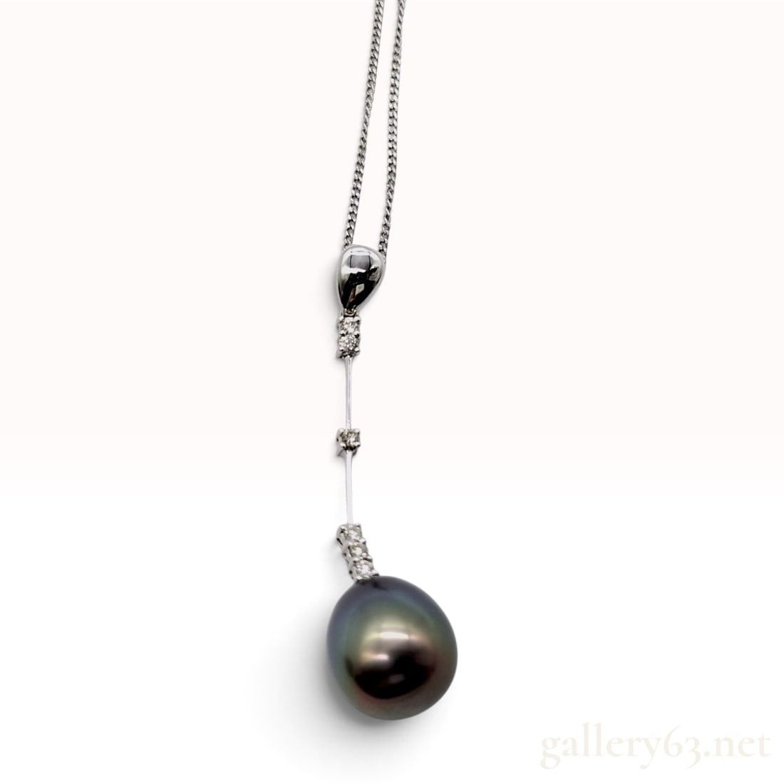 Tahitian Pearl and Diamond Platinum and 18K White Gold Drop Pendant Necklace: This necklace features a Tahitian black butterfly pearl and diamond drop pendant. The semi-round to drop-shaped cultured pearl measures approximately 10.2 mm in diameter and exhibits a high luster wit