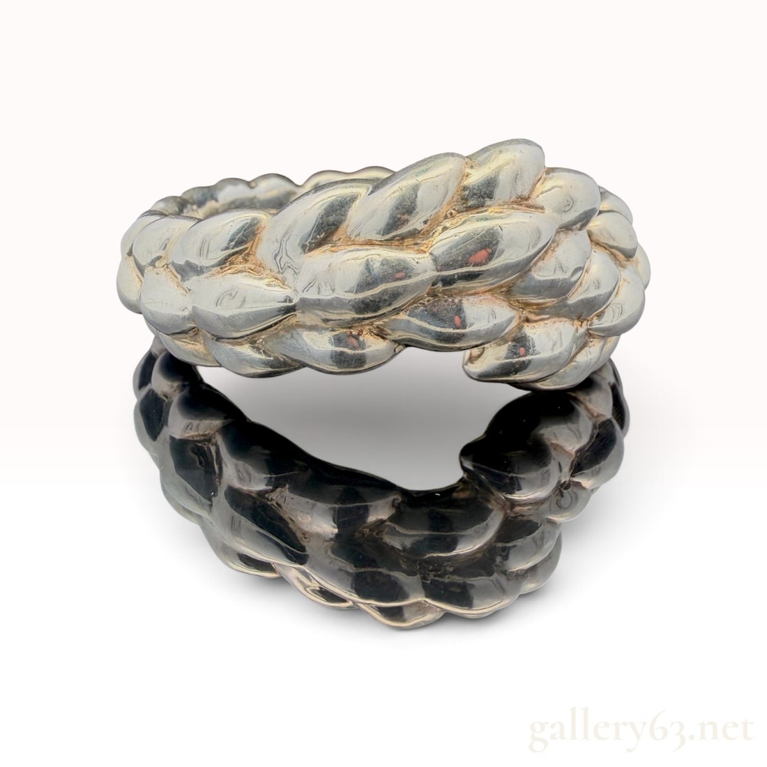 Large Sterling Silver Bangle Bracelet: The lot features a Large Sterling Silver Bangle Bracelet with 56.3 grams Sterling Over Resin.