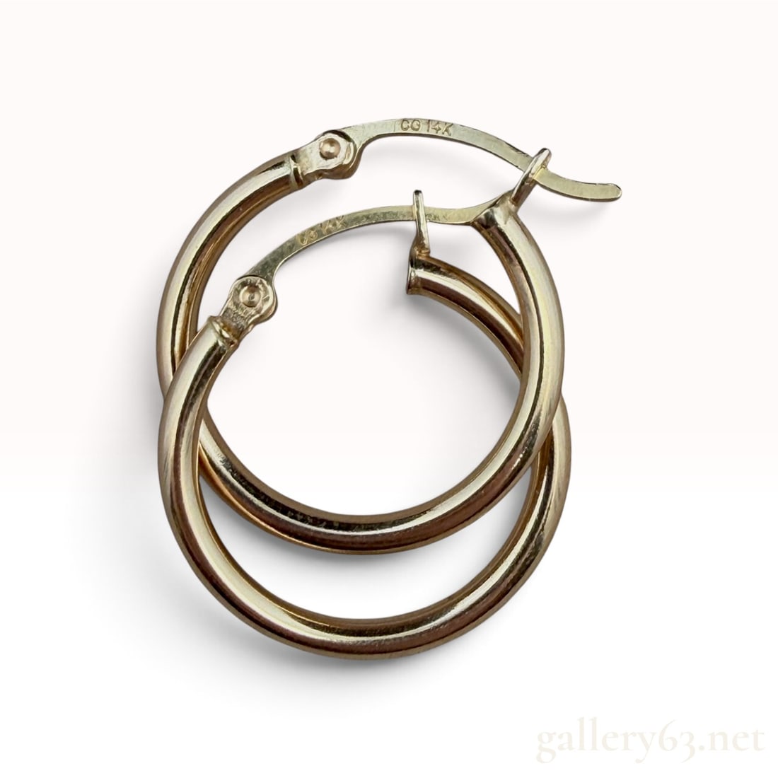 14k Yellow Gold Hoop Earrings: The lot features a pair of 14k Yellow Gold Hoop Earrings.