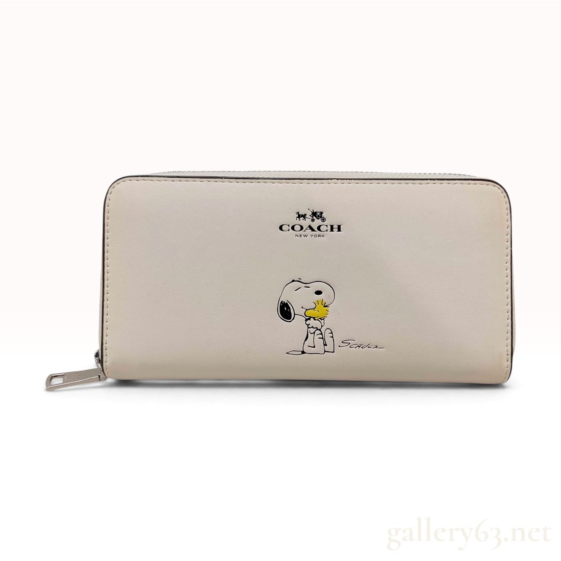 Coach x Peanuts Snoopy and Woodstock Accordion Zip Wallet in Chalk Leather: This is an accordion-style zip-around wallet from the Coach x Peanuts limited edition collection. The exterior is crafted from smooth chalk-colored leather and features a screen-printed graphic of