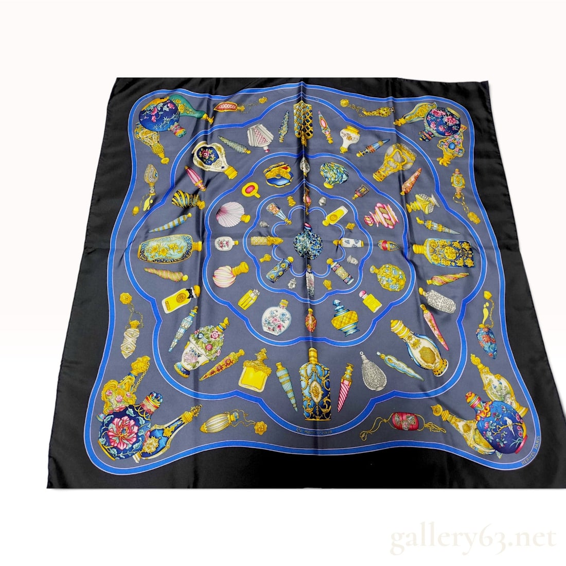 Hermes Qu'importe le flacon Silk Scarf by Catherine Baschet: This Hermes Carre 90 silk twill scarf features the Qu'importe le flacon pattern designed by artist Catherine Baschet, originally issued in 1988. The design illustrates a collection of ornate, multi-co