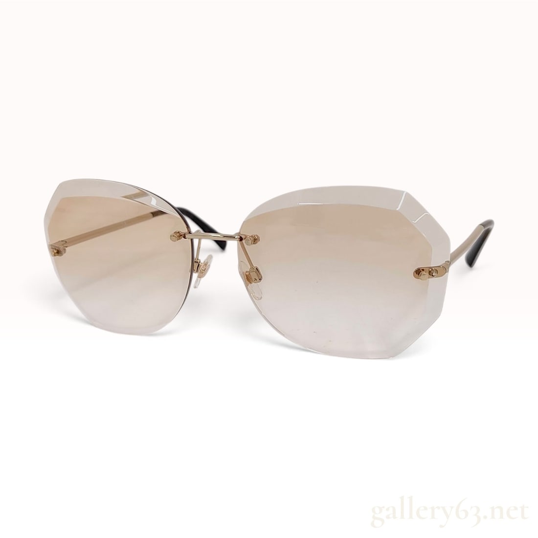 Chanel 4220 Rimless Butterfly Sunglasses with Brown Gradient Lenses: A pair of Chanel model 4220 rimless sunglasses featuring oversized, faceted octagonal lenses with a brown gradient tint. The glasses are constructed with a slim gold-tone metal bridge and temples equi