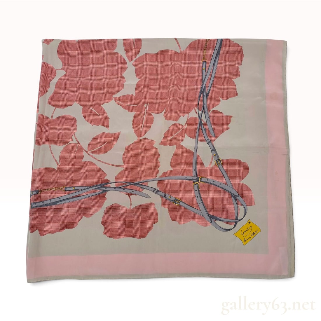 Vintage Gucci Wide Silk Scarf/foulard in Floral and Equestrian Motif: A vintage silk scarf from the Gucci Accessory Collection featuring a graphic design of stylized red and white houndstooth floral silhouettes on a beige ground. The print is overlaid with gray equestri