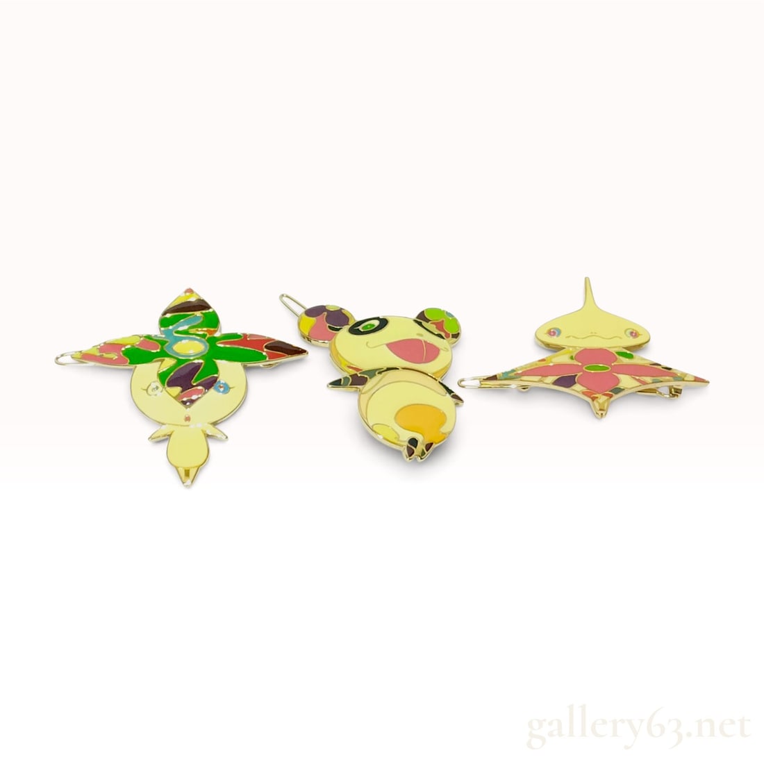 A Trio of Louis Vuitton x Takashi Murakami Multicolor Enamel Barrettes: This set of hair accessories is from the collaboration between Louis Vuitton and Japanese artist Takashi Murakami. The set consists of three gold-toned metal hair clips decorated with vibrant, multi-c
