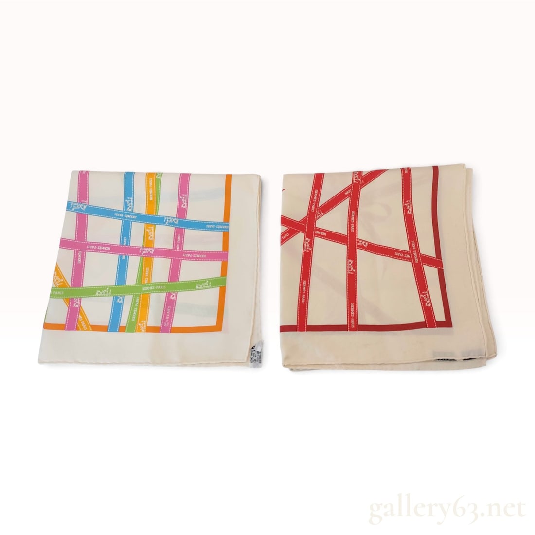Two Hermes Bolduc Ribbon Silk 90cm Scarves: A pair of Hermes 100% silk twill scarves featuring the house's signature Bolduc ribbon motif. The design consists of overlapping ribbons printed with the house signature Hermes - Paris and the carriag