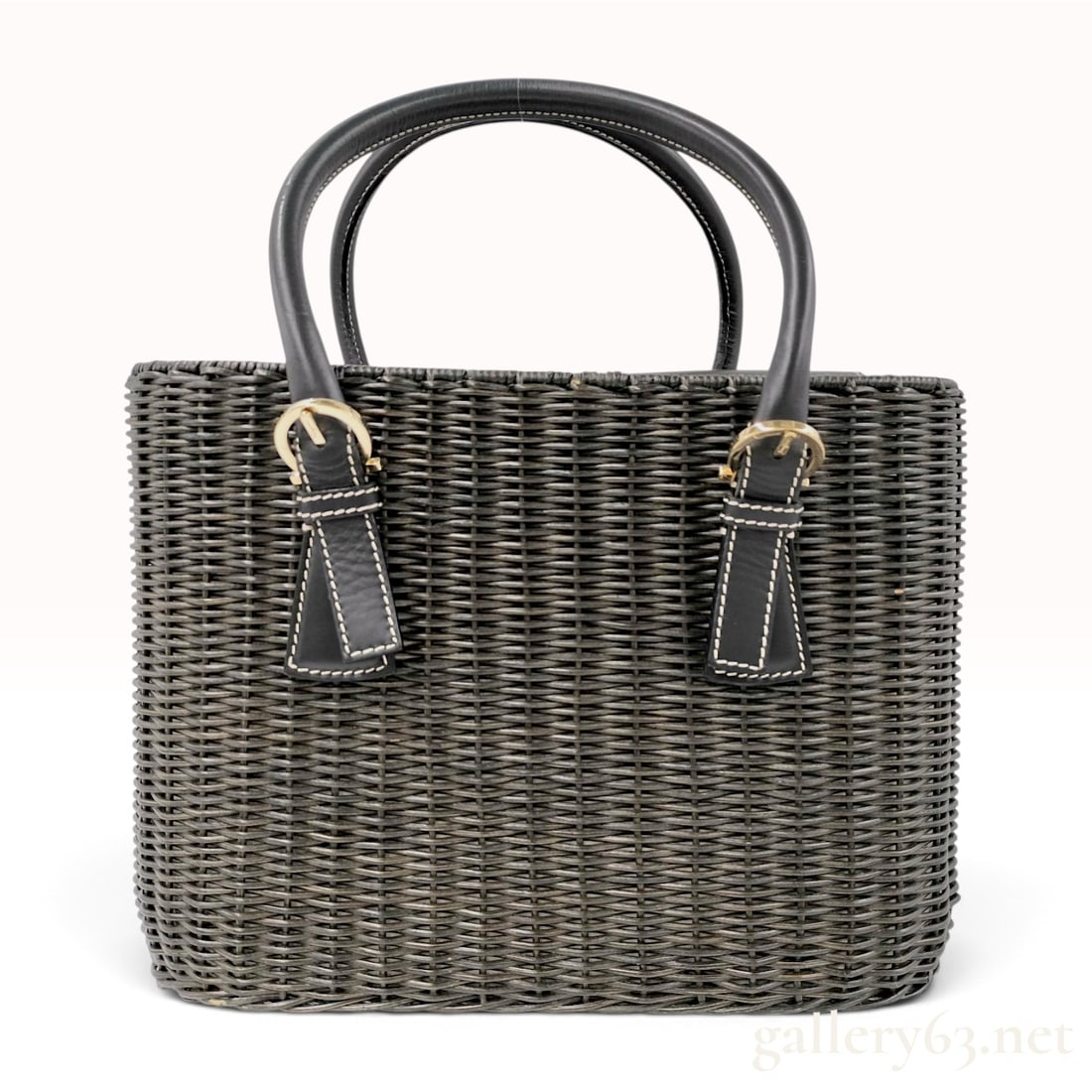 Salvatore Ferragamo Structured Charcoal Gray Wicker and Black Leather Tote Bag: A structured tote bag by Salvatore Ferragamo featuring a woven wicker body in a dark charcoal gray finish. The bag is constructed with black leather trim, including a top flap and two rolled leather h