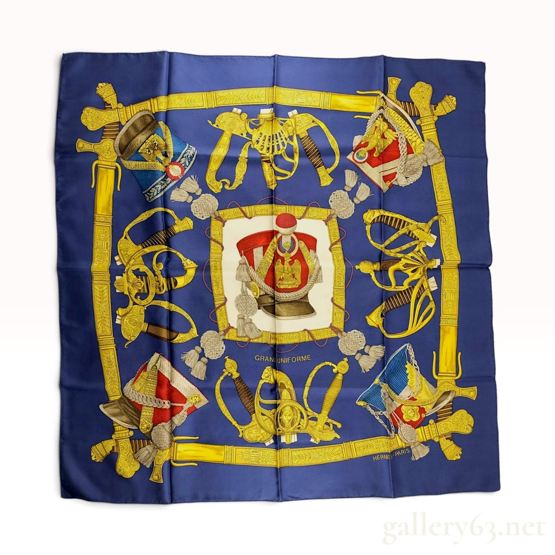 Hermes Grand Uniforme Silk Scarf designed by Joachim Metz: A square silk twill scarf from Hermes featuring the Grand Uniforme pattern designed by artist Joachim Metz. The design features a central white field depicting a plumed shako military hat, surrounded 