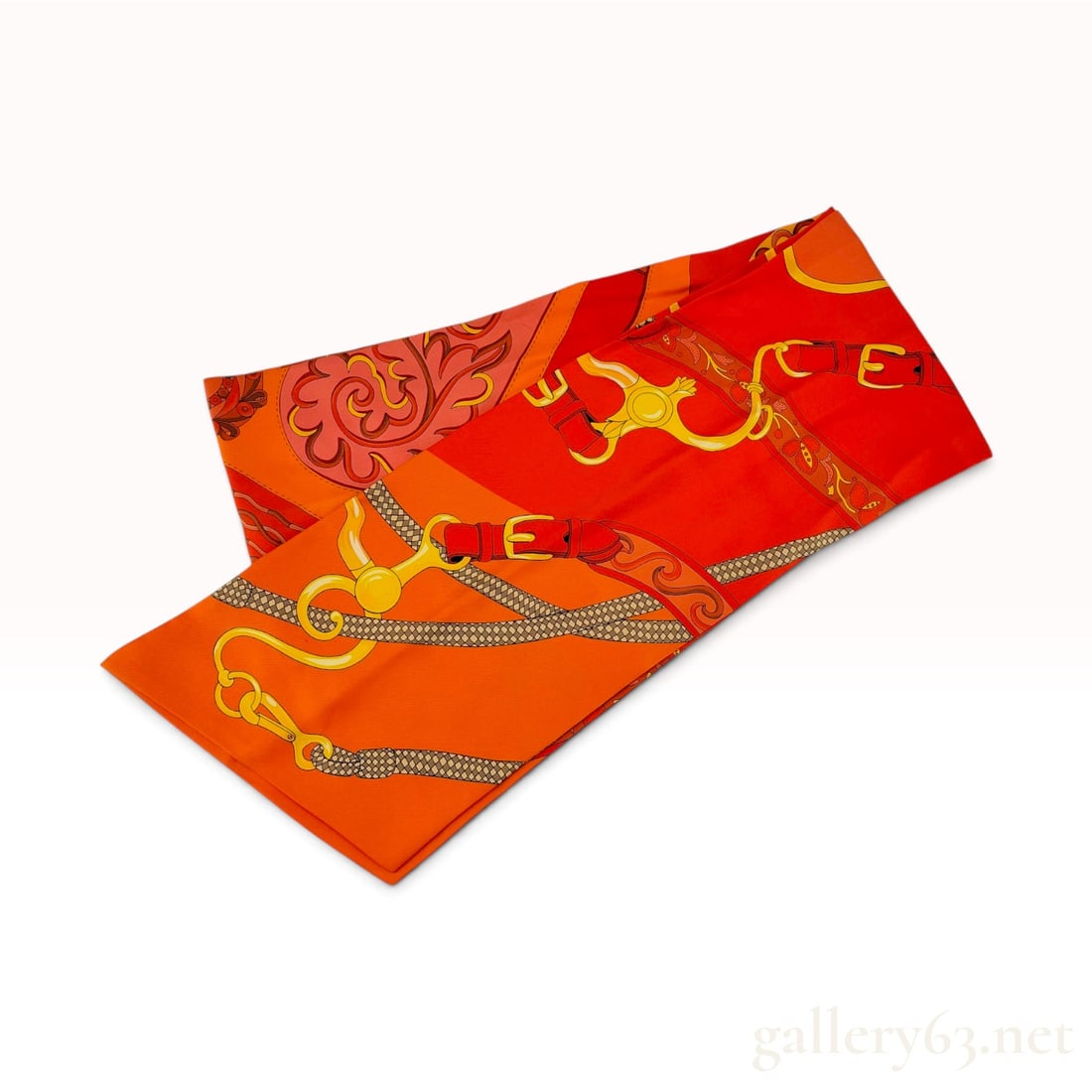 Hermes Festival Des Amazones Maxi-Twilly Silk Scarf: An Hermes silk twill maxi-twilly scarf in the Festival Des Amazones pattern. This long, narrow ribbon-style accessory features an equestrian motif composed of interlaced horse bits, bridles, and