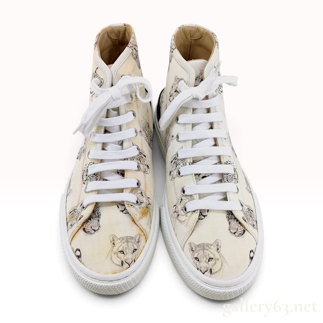 Hermes Animal Print Canvas High Top Sneakers Size 39: Excellent pre-owned condition. This pair of Hermes high-top sneakers is crafted from cream canvas featuring a grayscale illustrative animal print. The pattern consists of various big cat portraits,