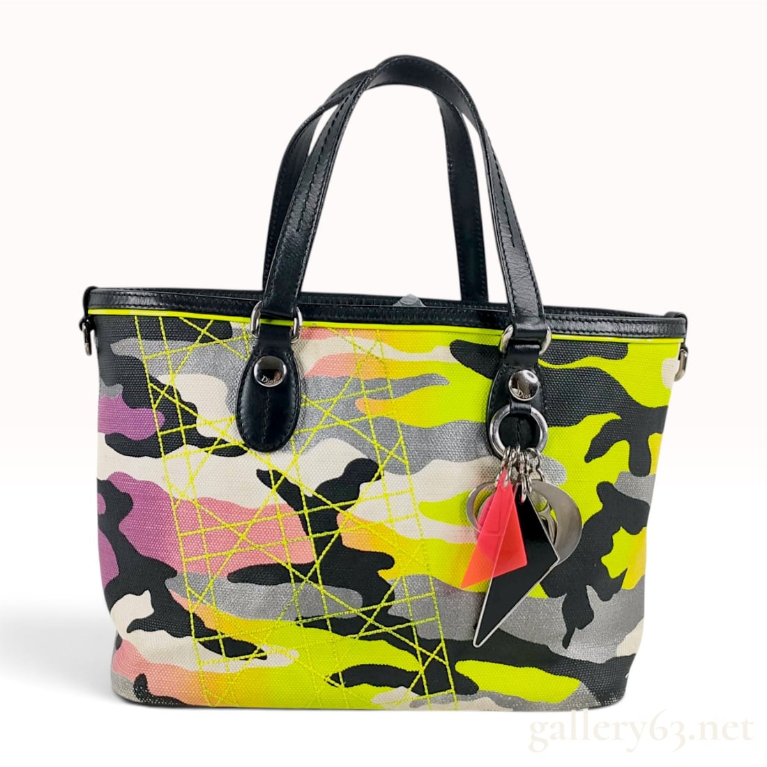 Christian Dior x Anselm Reyle Camouflage Canvas Tote Bag: This Christian Dior tote bag is from the 2011/2012 limited edition collaboration with artist Anselm Reyle. The bag features a vibrant camouflage print canvas exterior in neon yellow, pink, gray,