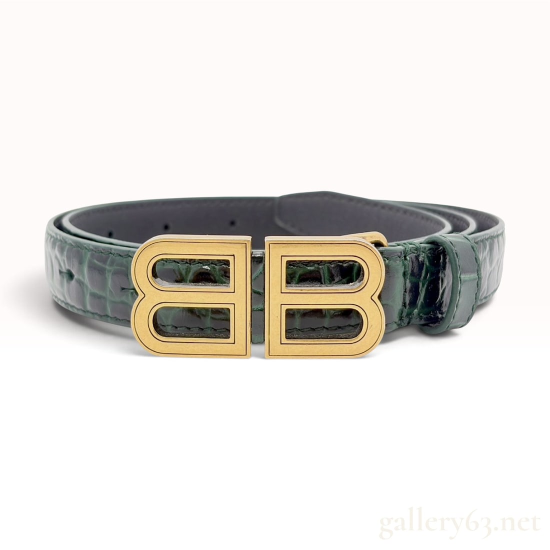 Balenciaga Forest Green Croc-Embossed Leather BB Logo Waist Belt: A Balenciaga designer waist belt featuring a forest green croc-embossed leather exterior and a smooth black leather interior lining. The belt is accented with a large interlocking BB logo buckle in