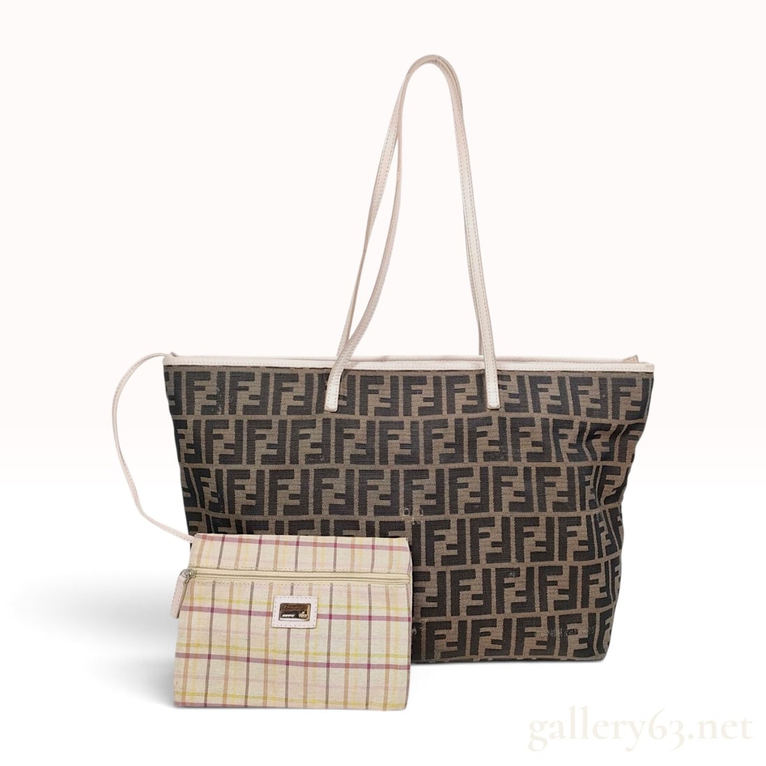 Fendi Zucca Monogram Canvas Roll Tote Bag with Accessory Pouch: This Fendi Roll Tote is constructed from the brand's signature Zucca monogram jacquard canvas in shades of brown and tan. The bag features off-white to beige leather trim along the top edge, corner