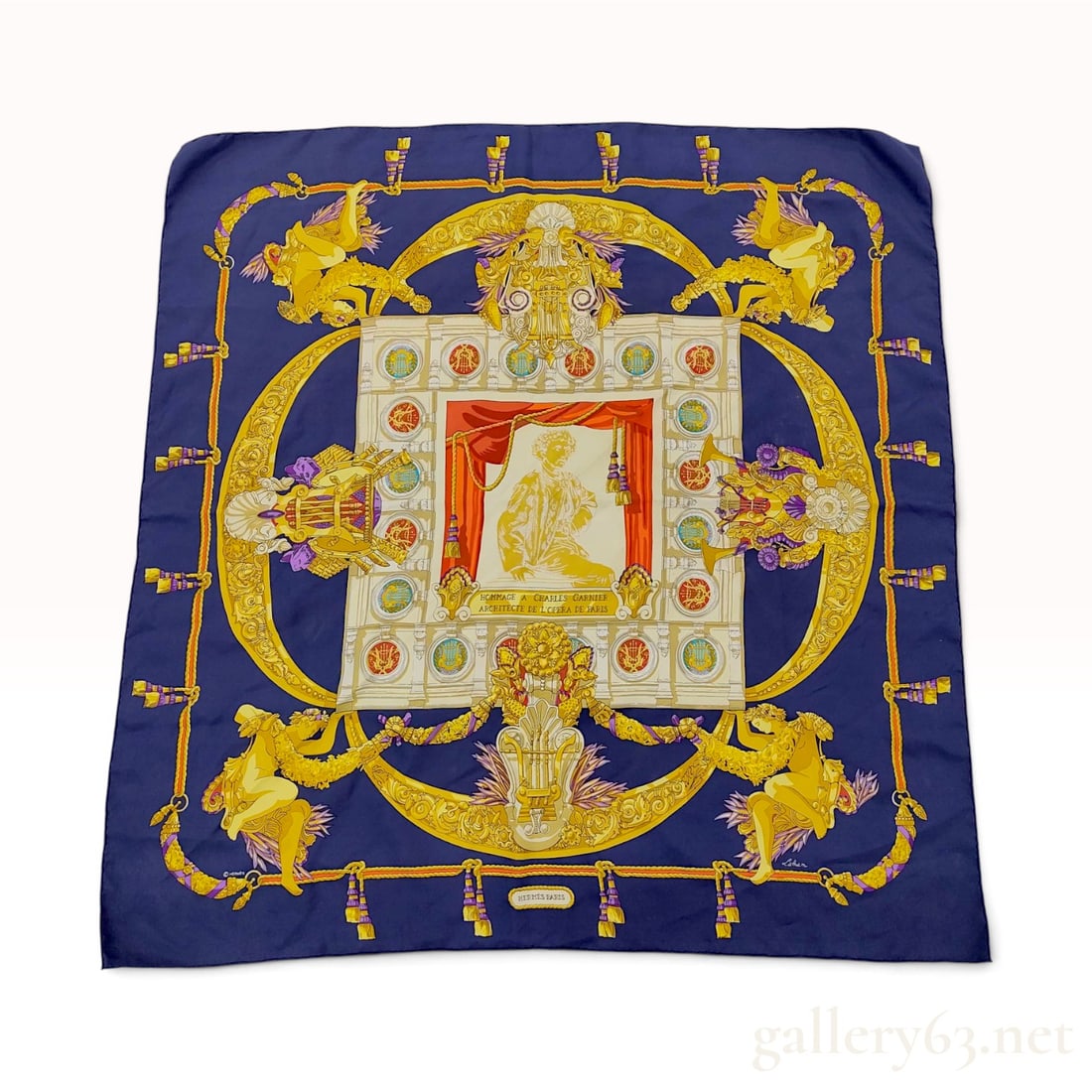 Hermes Silk Twill Scarf Hommage a Charles Garnier Catherine Latham: An Hermes 90 cm silk twill scarf featuring the pattern Hommage a Charles Garnier Architecte de l'Opera de Paris, designed by artist Catherine Latham. The design is centered on a gold-toned portrait
