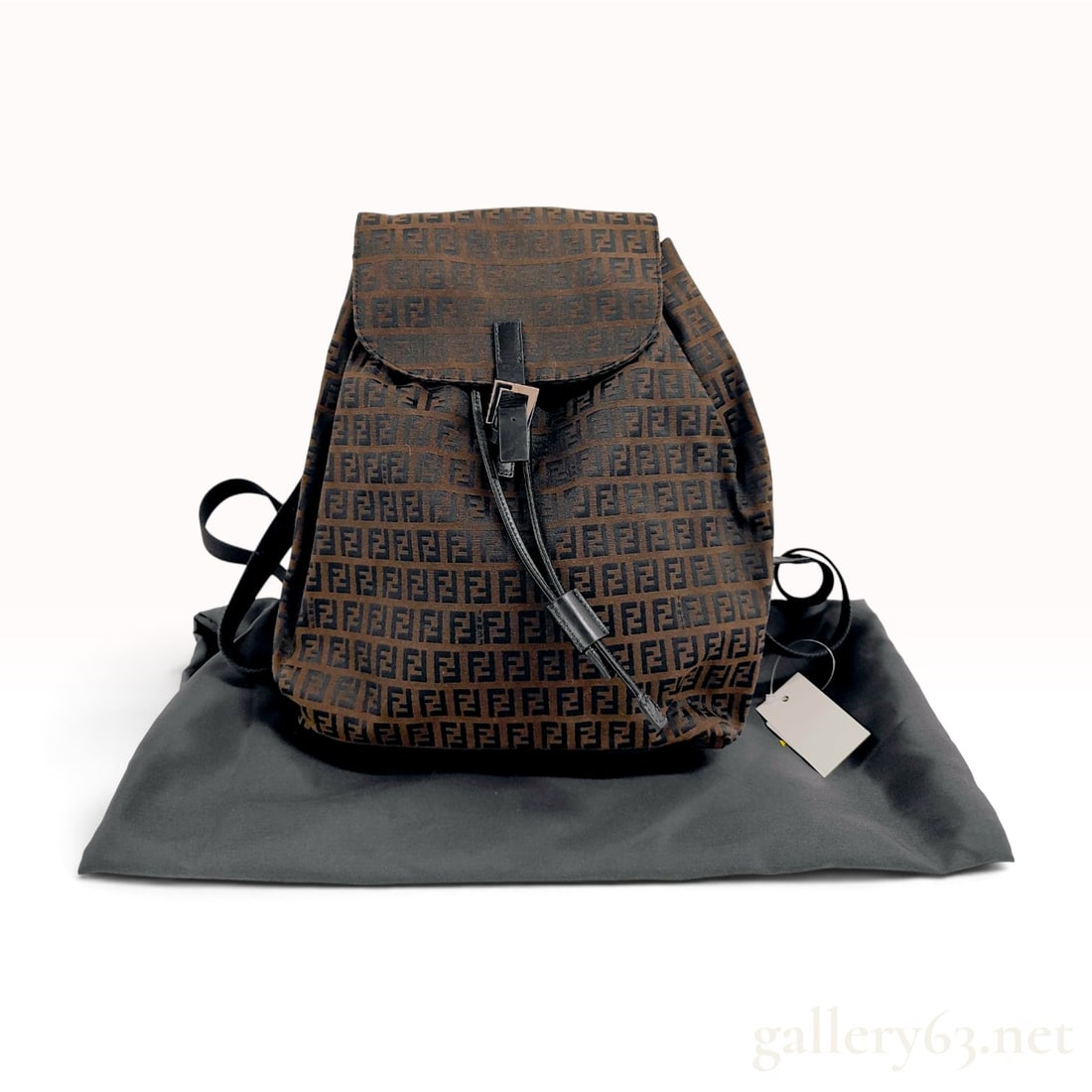 Fendi Zucca Monogram Canvas Backpack: This Fendi backpack is constructed from the signature Zucca monogram jacquard canvas in shades of brown and black. The bag features black leather trim, a top carry handle, and adjustable black textile