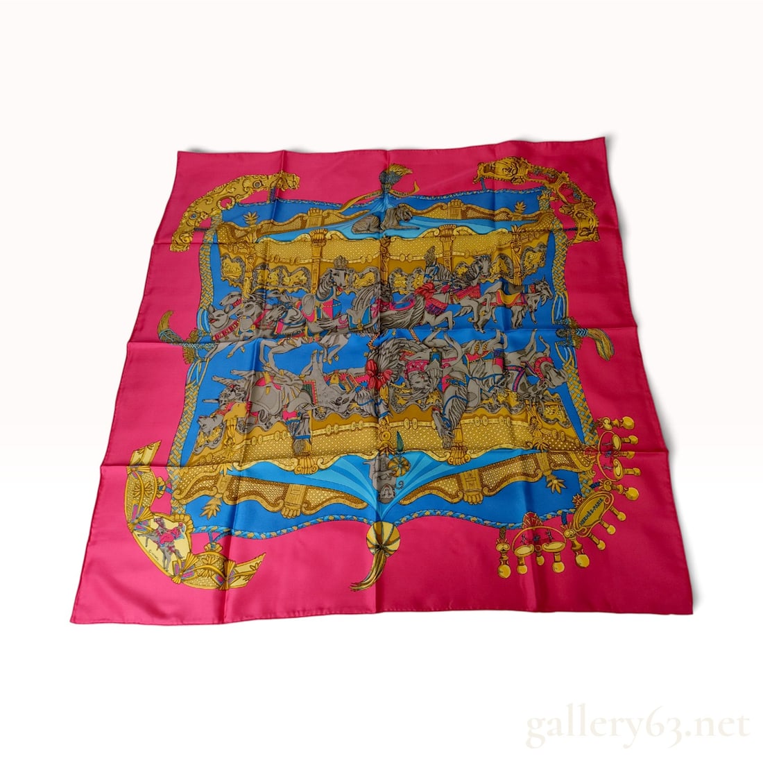 Hermes Tournez Manege Silk Scarf Designed by Cathy Latham: This is a vintage Hermes silk scarf featuring the Tournez Manege pattern, originally designed by artist Cathy Latham and first issued in 1982. The composition centers on a vibrant carousel theme set a