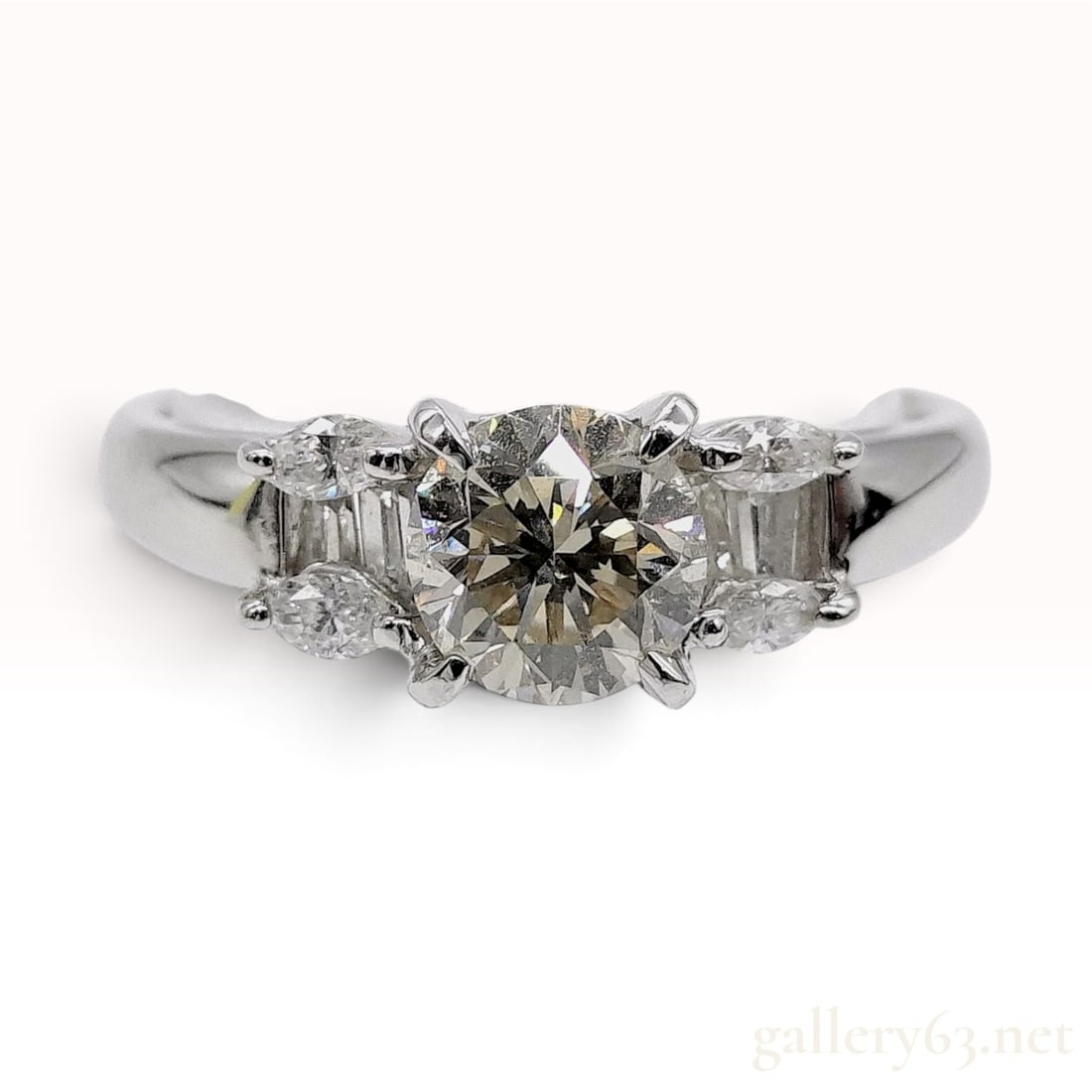 Platinum and 1.081ct/1.34ctw Natural Diamond Ring: A platinum and diamond engagement ring featuring a centrally set round brilliant-cut diamond. The center stone has a weight of 1.081 carats as indicated by the interior band hallmark. The shoulders of