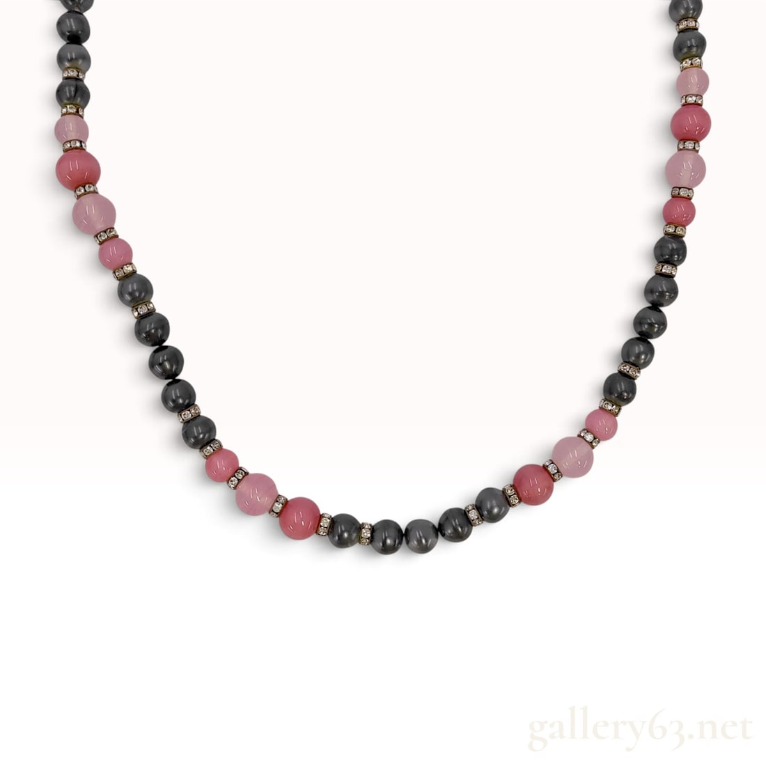 Christian Dior Bijoux Vintage Beaded Necklace with Crystal Spacers: A vintage Christian Dior Bijoux beaded necklace featuring a repeating pattern of metallic dark gray, translucent pale pink, and opaque salmon pink round beads. Each bead is separated by a gold-toned m