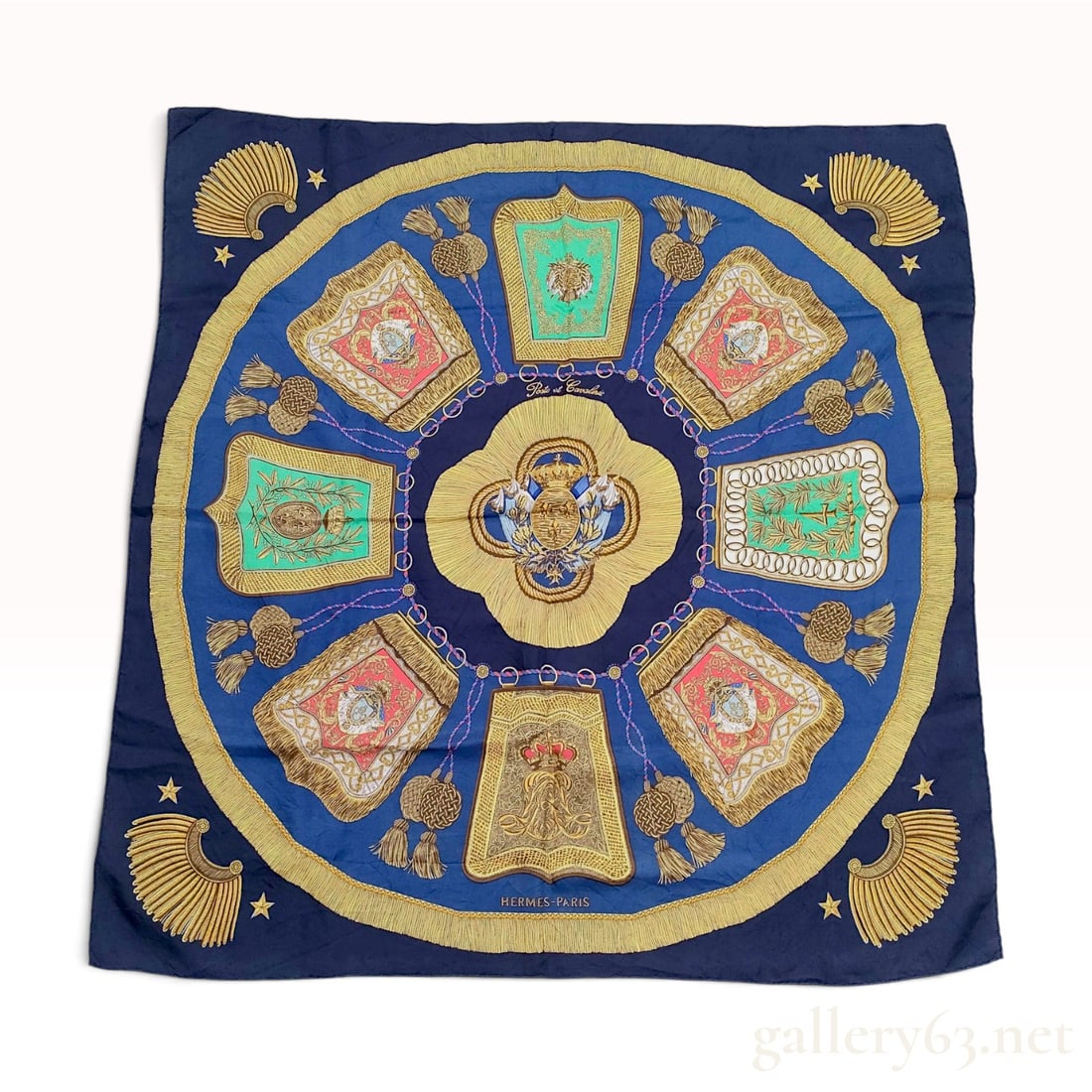 Hermes Poste et Cavalerie Silk Scarf by Joachim Metz 90cm: This silk twill scarf features the Poste et Cavalerie design by Joachim Metz for Hermes. The central motif depicts a heraldic crest within a circular gold-toned frame, surrounded by eight military sab