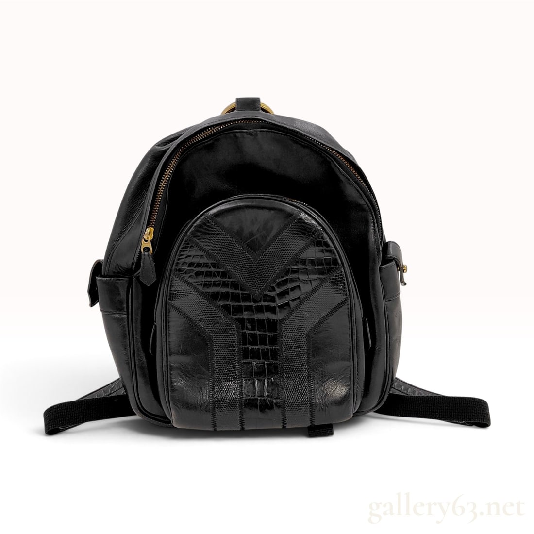 Vintage Yves Saint Laurent Mixed Texture Black Leather Y Line Backpack: This vintage Yves Saint Laurent backpack is constructed from black smooth leather accented by decorative panels of embossed exotic-textured leather featuring crocodile and lizard patterns. The front o