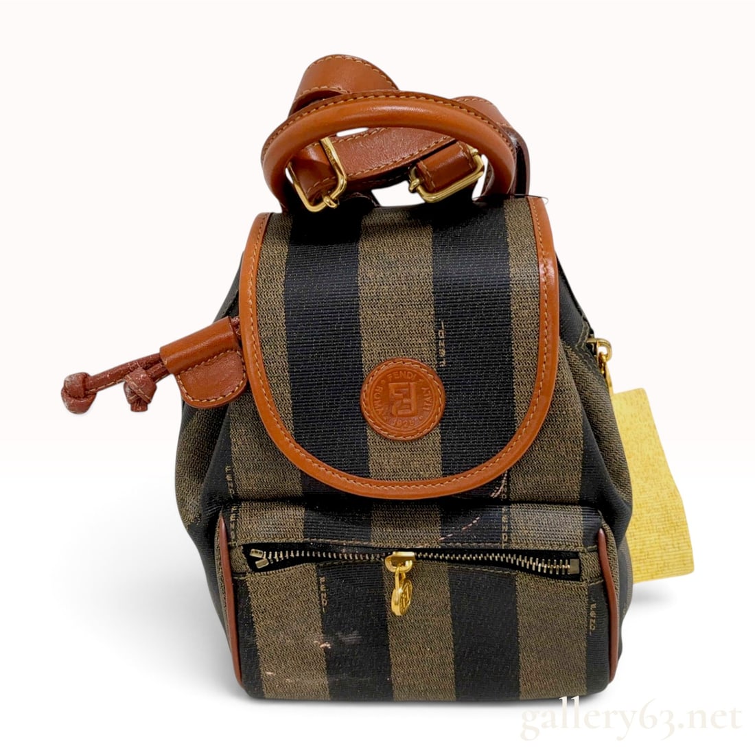 Fendi Vintage Pequin Striped Coated Canvas Mini Backpack: A vintage Fendi mini backpack featuring the signature Pequin striped coated canvas in brown and black. The bag is accented with smooth cognac brown leather trim, piping, and adjustable shoulder straps