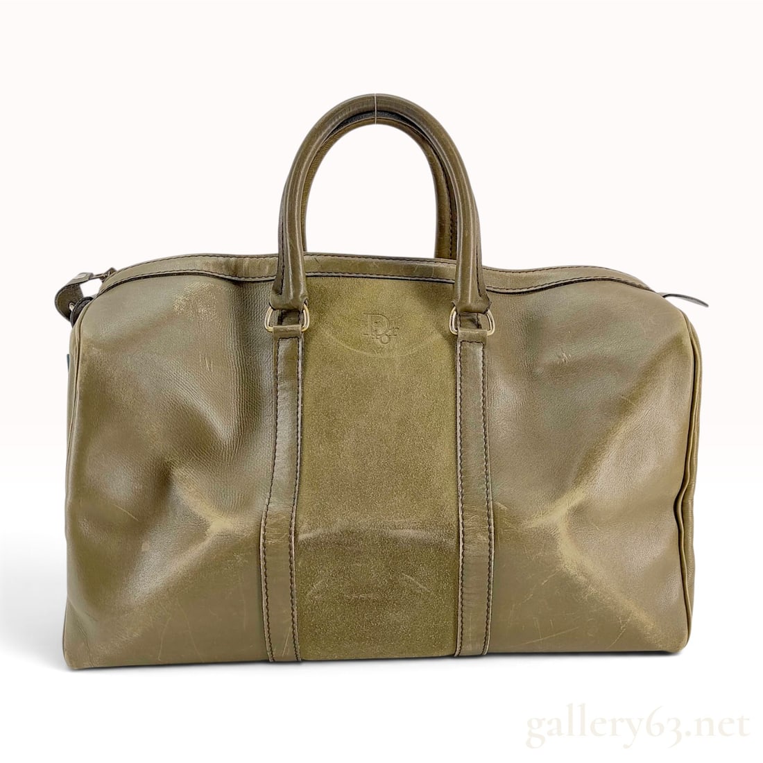 Vintage Christian Dior Olive Green Grained Leather and Suede Boston Travel Bag: This Christian Dior travel weekender bag is constructed from olive green grained leather featuring a central vertical panel of tonal suede. The bag is designed in a classic Boston silhouette with two 