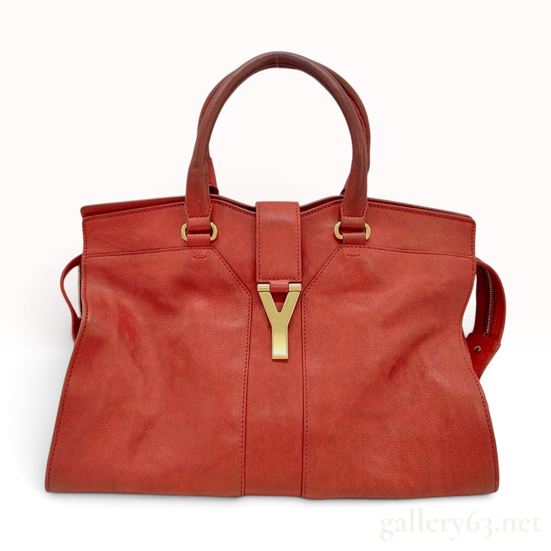 Yves Saint Laurent Red Grained Leather Large Cabas Chyc Satchel: A large Yves Saint Laurent Cabas Chyc satchel crafted in red grained calfskin leather with gold-tone hardware. The bag features a structured silhouette with double rolled leather handles and signature
