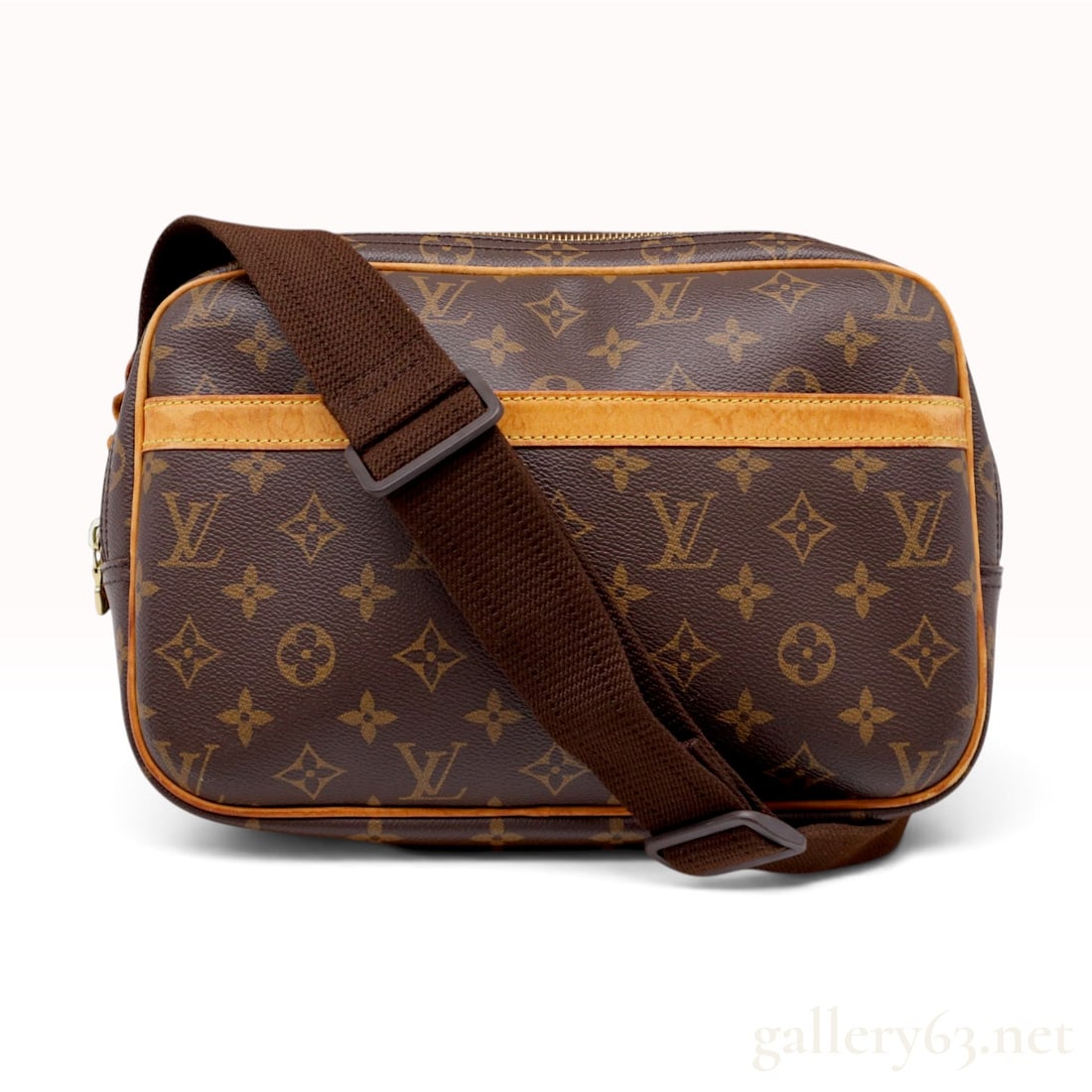 Louis Vuitton Monogram Reporter PM Crossbody Bag: A Louis Vuitton Reporter PM handbag featuring the signature Monogram coated canvas exterior with natural cowhide vachetta leather trim and piping. The bag is designed with two separate large compartme