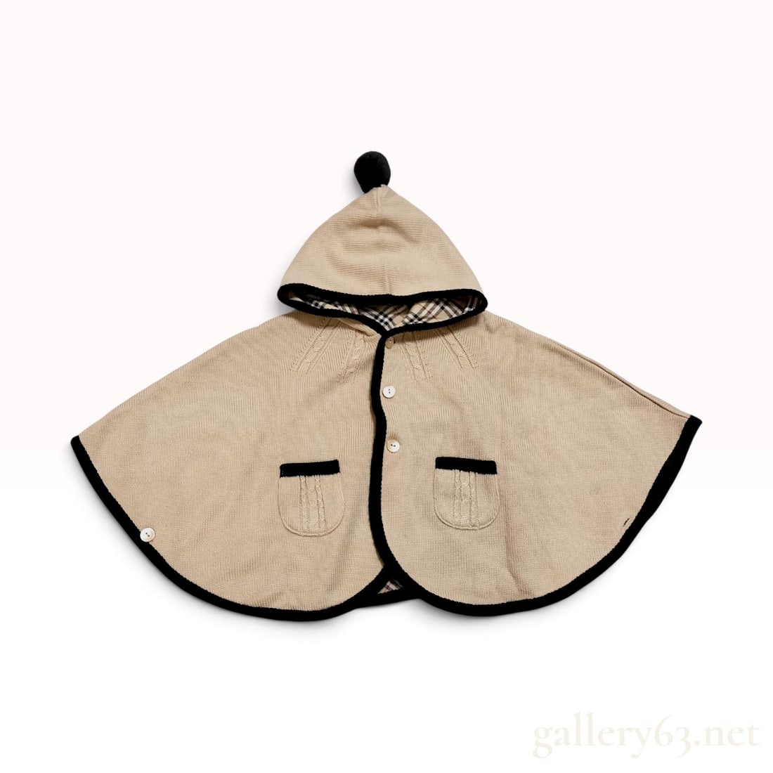 Burberry London Child's Reversible Hooded Knit Cape: This child's reversible hooded knit cape is by Burberry London, manufactured in Japan under license by Sanyo Shokai Co., Ltd. The garment features a dual-layer construction with a beige wool-blend kni