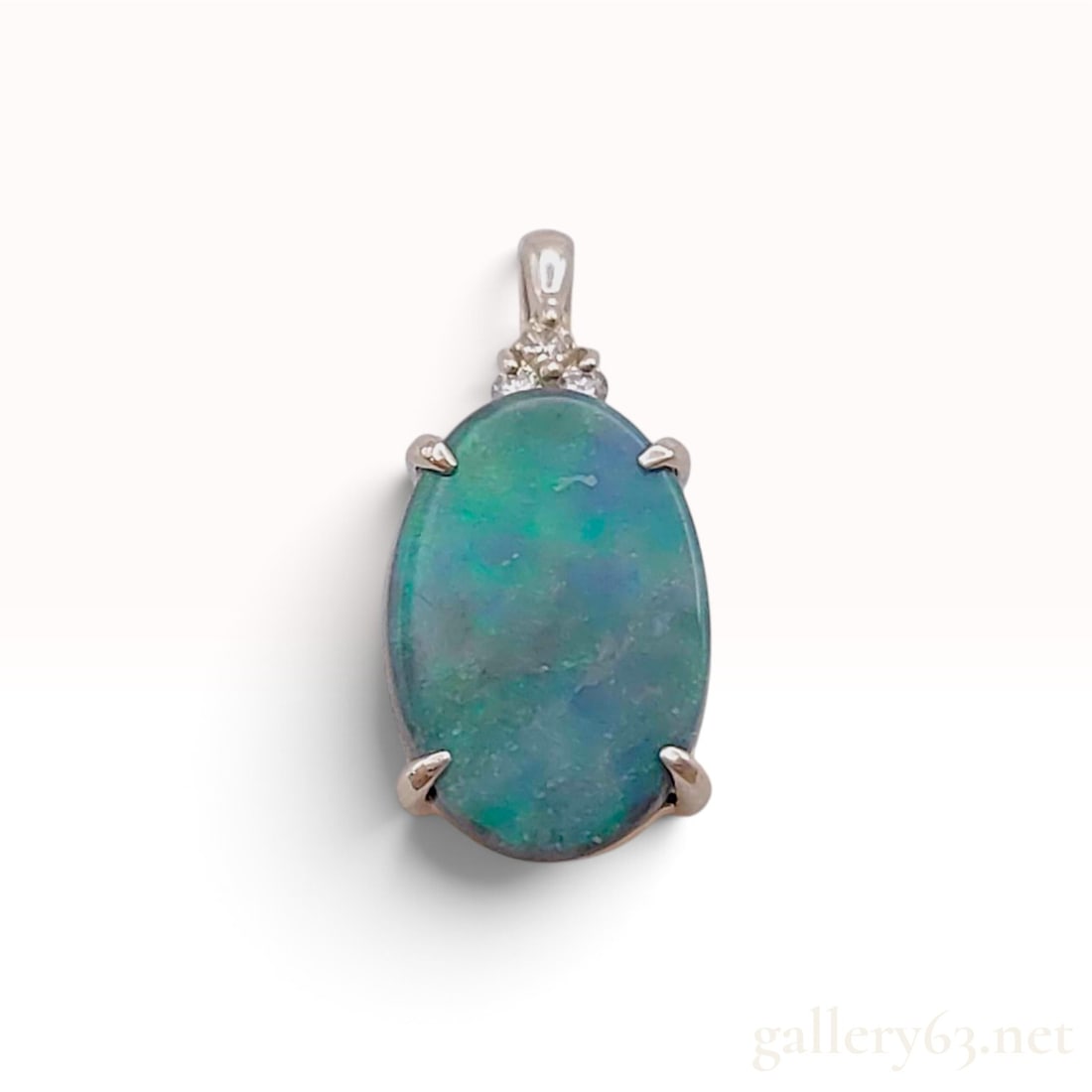 14K White Gold 1.00ct Black Opal and 0.02ctw Natural Diamond Pendant: This item is in excellent condition. A 14 karat white gold pendant featuring a central oval black opal doublet weighing 1.00ct. The gemstone displays a play-of-color with predominant green and blue fl