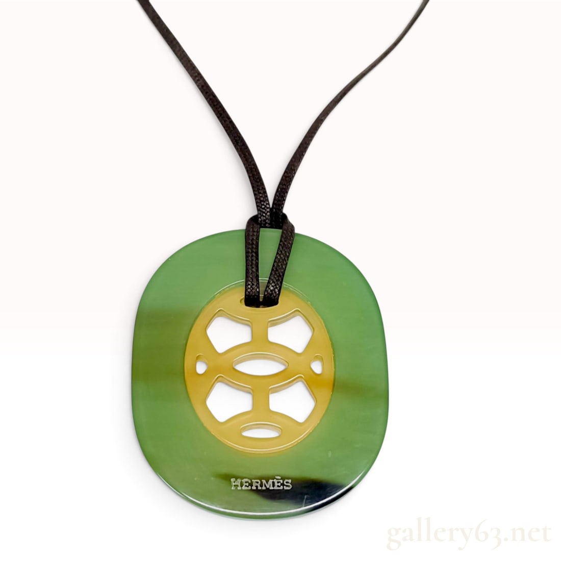 Hermes Lift Reversible Lacquered Buffalo Horn Pendant Necklace: A Hermes Lift reversible pendant necklace featuring a large oval frame crafted from lacquered buffalo horn. The pendant is reversible, finished in green lacquer on one side and turquoise blue lacquer 