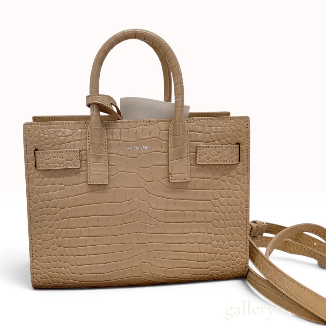 Saint Laurent Crocodile-Embossed Calfskin Baby Sac de Jour Handbag: A Saint Laurent Baby Sac de Jour handbag constructed from nude crocodile-embossed calfskin leather with silver-tone hardware. The bag features a structured tote design with accordion side panels and d