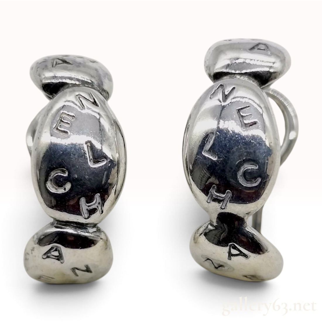 Chanel Sterling Silver Logo Clip-on Hoop Earrings: A matched pair of Chanel sterling silver clip-on hoop earrings. Each earring features a chunky, organic design composed of three interconnected bulbous segments. The exterior surface of the segments i